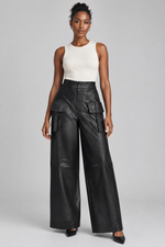 Load image into Gallery viewer, On-model view showing the black pants’ silhouette and cargo details

