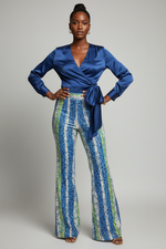 Load image into Gallery viewer, Sequined pants with blue satin side tie wrap shirt on African American model
