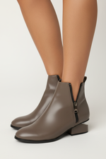Load image into Gallery viewer, Taupe ankle boots on brown-skinned model
